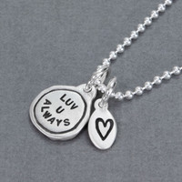 Side view of handmade silver Luv U Always pendant, hung on silver chain with silver stamped heart charm