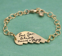 Side view of gold memorial handwriting angel wing bracelet personalized with your loved ones actual handwriting