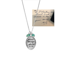 Original Valentine's Day note, with husband's handwriting, engraved on silver Large oval handwriting memorial necklace, with blue green birthstones, on a white background