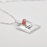 Raised edge handwriting heart necklace, shown from side with pink stone