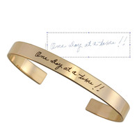 Gold handwriting cuff memorial bracelet, with passed loved one's actual handwritten note on the outside, shown with original note used to personalize it