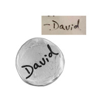 Handwriting on a fine pewter pocket charm, shown on white, with the original handwritten signature "David" used to personalize it