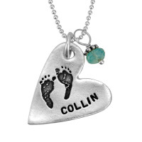 Custom silver heart necklace, personalized with child's actual footprints and a birthstone, shown close up on white