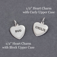 Hand stamped 1/2" sterling silver heart charms stamped in Curly Upper Case font with "Emilie" and in Upper Block font with "Bud"