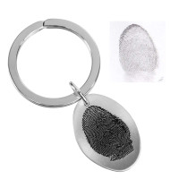 fingerprint key ring memorial in sterling silver on a white background. shown with the original fingerprint