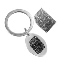 fingerprint key ring memorial in sterling silver on a white background. shown with the original fingerprint