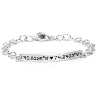 Silver personalized hand stamped coordinates bracelet, shown on white