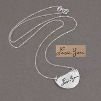 Actual handwriting on custom silver half circle pendant necklace, shown with original handwritten note, on gray
