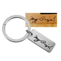 Custom memorial Silver key ring shown with actual handwriting from husband used to personalize it, on white background