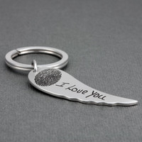 Custom silver angel wing key ring personalized with your loved one's actual fingerprint & handwriting, shown from the side