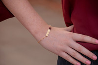 Dainty bracelet with your actual writing in gold, shown on a model