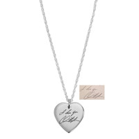 Wide view of custom silver heart necklace, engraved with husband's handwritten signature, shown on white with the handwriting used to personalize it