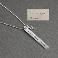 Memorial custom silver Handwriting Tag Necklace, personalized with late mom's signature, with cross charm, shown from side view on gray