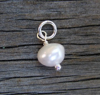 Freshwater Pearl (June), shown on wood