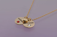 Gold Disc with Crystal Birthstones Necklace, hand stamped with kids names , shown from the side