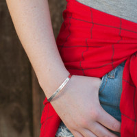 Model wearing custom Hand-Stamped Bracelet in Sterling Silver Mom Bracelet, personalized with kids names and meaningful words