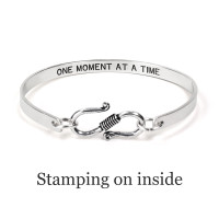 Personalized sterling silver bracelet, hand stamped with inspirational message on the inside, shown from the back on a white background