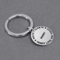 Custom hand stamped silver key chain for mom, personalized with kids' names, shown from the side
