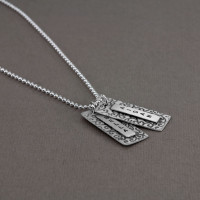 Long Patterned Rectangle necklace, sterling tags hand stamped with names, soldered on a vine patterned silver background charm, shown from the side