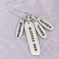 Silver Mom Tags Necklace, stamped with kids names, shown from the side