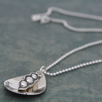 Sterling silver My Peas Necklace, custom hand stamped with kids names and a peas in a pod charm, with a pea for each child, shown from the side