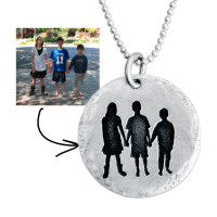 Sterling silver disc charm with etched silhouette of three kids