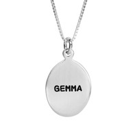 Custom sterling silver oval charm necklace, personalized with hand stamped name Gemma in Block Upper font, shown close up on white