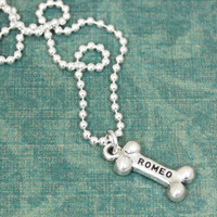 Sterling silver Dog Bone Necklace, shown from the top, with the dog's name stamped on the bone charm