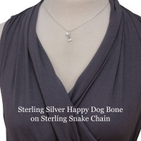 Model wearing sterling silver dog bone charm with hand stamped name "Maggie", shown on a sterling silver snake chain