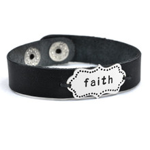 Hand stamped leather cuff shown with word "faith"