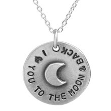 Hand stamped to the moon pendant with raised moon close up on white