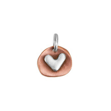 handmade copper and silver heart charm, with optional hand stamping on back, shown close up on white