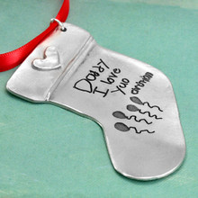 Custom fine pewter stocking shaped ornament, personalized with child's artwork and handwritten note to dad, shown from the side on green