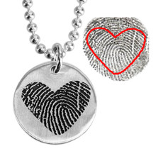 Custom Silver fingerprint necklace, personalized with loved one's actual fingerprint, shown close up on white, with the original fingerprint used to personalize it, highlighted to show where the print cut out came from