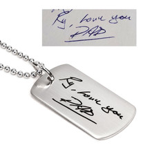 Custom silver dog tag memorial necklace with Dad's handwriting, with the original handwritten note used to create it, shown on white