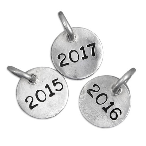 Hand stamped silver year charm for teachers & grads shown on white