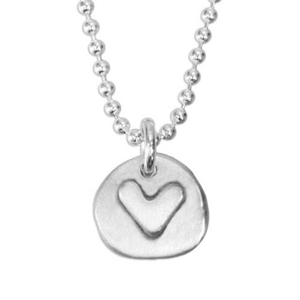handmade silver circle charm with raised heart, on a silver ball chain, shown close up on white