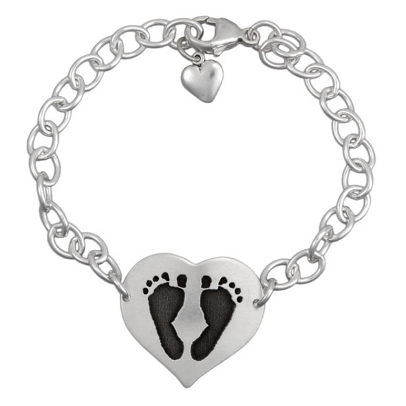 Custom silver heart bracelet personalized with your child's actual footprints, shown on white