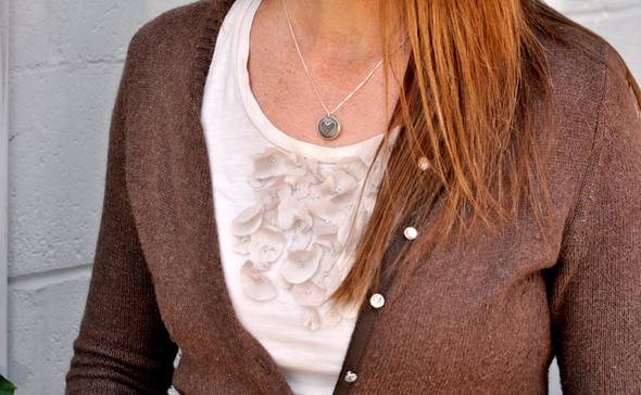 Silver Heart locket for mom with hand stamped message inside, shown on a model