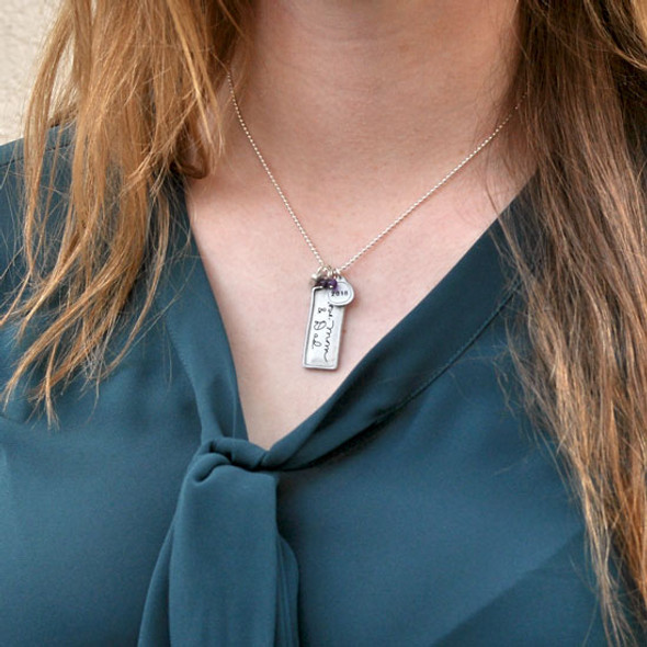 Established family necklace heirloom from silver rectangle, shown on a model