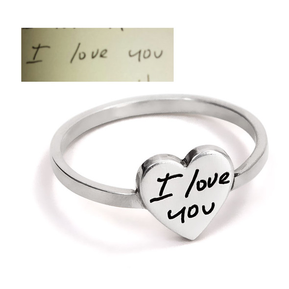 Custom Silver handwriting ring, with handwriting engraved on a silver heart, shown with the husband's actual handwritten "I Love You" used to personalize it. Shown close up on white