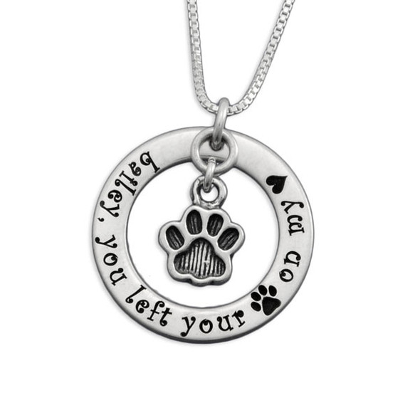 Silver circle necklace with Baily you left your paw on my heart, and a silver paw charm hanging within the circle, all on a silver chain (shown close up)