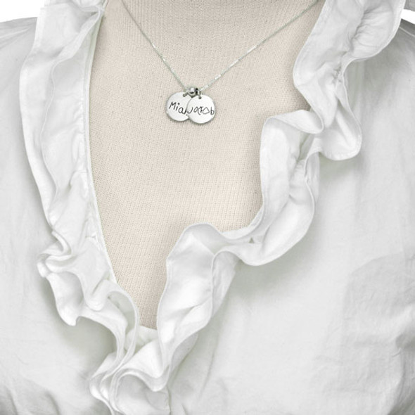 Model wearing custom silver handwriting jewelry charms personalized with child's signature and drawing
