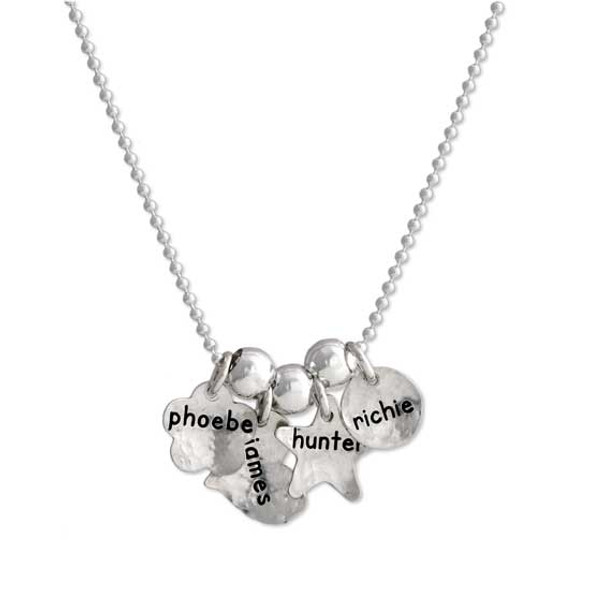 Custom silver Mom necklace, personalized with kids' names hand stamped on silver charms, shown on white