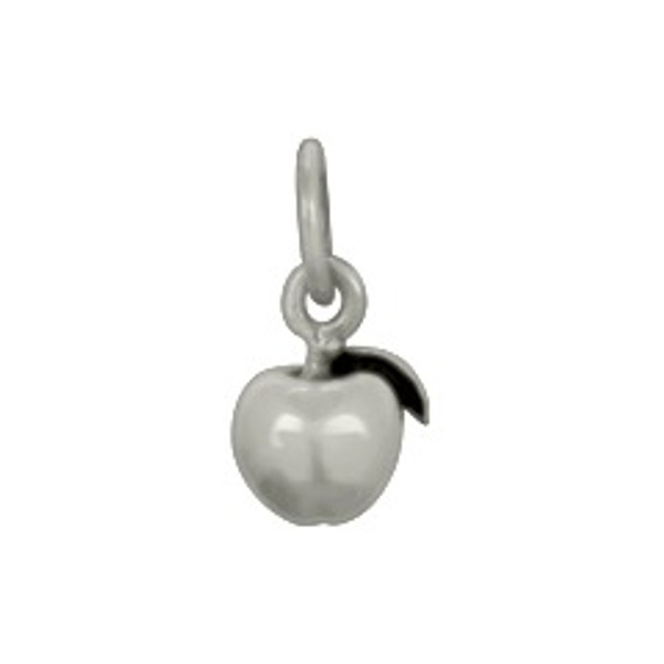 Tiny sterling silver apple charm for teachers, shown close up on white