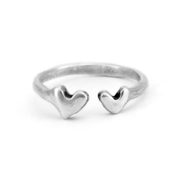 Hand crafted silver ring with two hearts, shown on white
