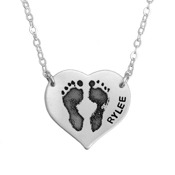 Sterling silver footprint necklace hanging from two holes in charm, with your child's actual footprints