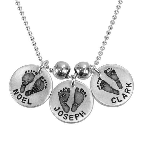 Custom Footprints/Handprints Silver Necklace, personalized with your kids' footprints or handprints, shown close up on white