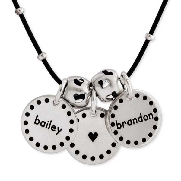 Dotted Border Sterling Silver Discs custom hand stamped with kids names and a heart, shown close up