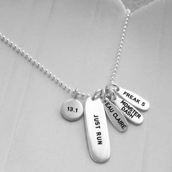 Custom silver Marathon Necklace with charms showing marathons she's run, dates & distances, and a large silver tag stamped with, "Just Run"